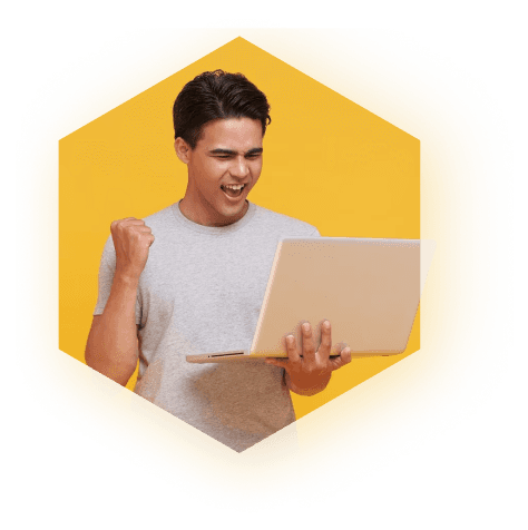 Man celebrating his success in freelancing career with a laptop - Dream Peak IT